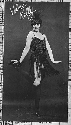 a black and white photo of a woman in a dress