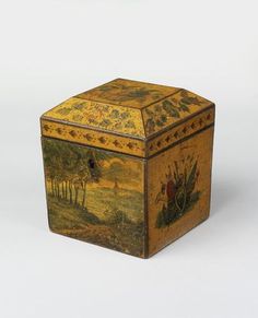 an ornately painted wooden box with animals and trees in the background on a plain white surface