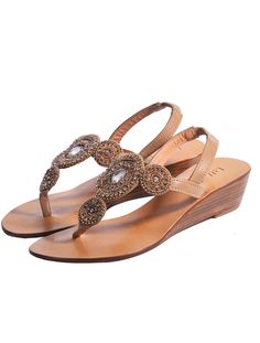 The Victoria Mini Wedge Sandal is handcrafted sewn beads and crystals stitched with sequins. Pair with your favorite floral dress, skinny jeans or shorts, these sandals will provide you everyday comfort with effortless style. You will fall in love with the comfort and never want to take them off! Elastic Leather ankle strap Smooth leather lining with embossed logo Lightly padded footbed Leather & rubber outsole Handmade in Bali Elegant Embellished Sandals For Vacation, Crystal Embellished Wedge Heel Sandals, Elegant Embellished Wedge Heel Sandals, Embellished Wedge Sandals For Beach, Embellished Wedge Heel Sandals For Summer, Embellished Wedding Sandals For Summer, Embellished Wedge Heel Sandals For Beach, Boho Chic Shoes, Red Leather Shoes