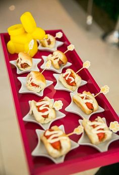 hotdogs with mustard and ketchup on a red tray