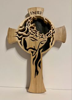 a wooden cross with an image of a tree on it