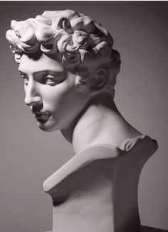 a black and white photo of a statue of a man's head with curly hair