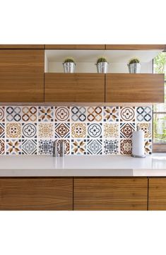 an image of a kitchen setting with decorative tiles on the backsplash and counter tops