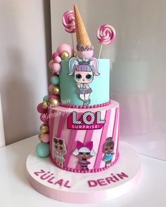 a three tiered cake decorated with candy and lollipops