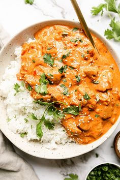 a white bowl filled with rice and chicken curry