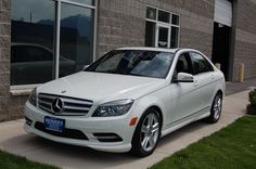 a white car parked in front of a building