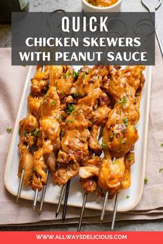 chicken skewers with peanut sauce on a white platter and text overlay