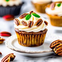 a cupcake on a plate with pecans around it