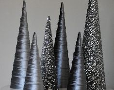 three black and white trees are on top of a cake with sprinkles