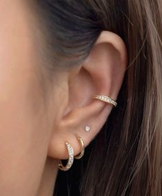 a close up of a person's ear with two different types of piercings