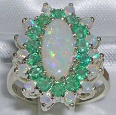 "*This large floral ring is made from 375 9K White Gold with Natural Semi-precious Opals & Precious Emeralds. PLEASE MAKE SURE YOU STATE THE FINGER SIZE YOU REQUIRE WITH YOUR PAYMENT. An impressive large 9ct White Gold Opal & Emerald Cluster ring set with a center 12x6mm Opal (0.48\"x0.24\" inches) , fourteen 2.75mm (0.11\" inches) Emeralds and fourteen 2.25mm (0.09\" inches) Opals. This large cluster ring is a real beauty and guaranteed to impress. It measures 20x14mm (0.80\" x 0.56\" inches) a Marriage Encouragement, Opal Eyes, Gem Rings, Cluster Ring Set, Antique Style Rings, Ring Cluster, Precious Opal, Floral Ring, Classic Ring