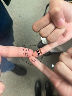 two people holding up their fingers with the letters b and f written on them in different languages