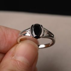 This is a gorgeous handmade creation. Its beauty is its simplicity & Elegance. The 6*8mm oval shape faceted natural black spinel is crafted in solid sterling silver and with rhodium plated. All item is sent in a beautiful gift box If you have any idea of design your ring,pls contact me directly. You can realize more lovely stuff clicking the link https://www.etsy.com/shop/knightjewelry?refshopsection_shophome_leftnav Please leave the correct address and you phone number for delivering succes Classic Black Sapphire Oval Ring, Classic Black Oval Sapphire Ring, Classic Oval Black Spinel Jewelry, Black Oval Sapphire Promise Ring, Classic Black Sapphire Ring In Sterling Silver, Black Sterling Silver Birthstone Rings, Black Sterling Silver Rings With Birthstone, Black Sapphire Ring With Polished Finish As Gift, Gift Black Sapphire Ring With Polished Finish