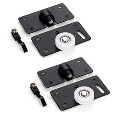 three black latches and two white knobs on the back of a pair of doors