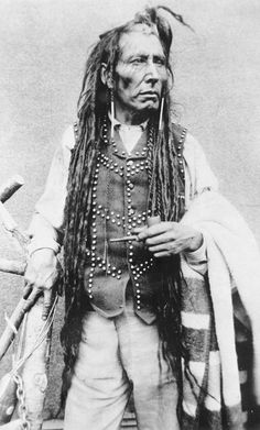 an old black and white photo of a native american man