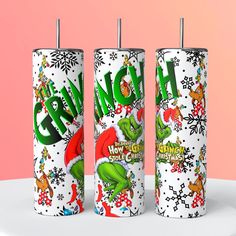 three christmas candles with the words grin on them and santa hats, snowflakes, and reindeers