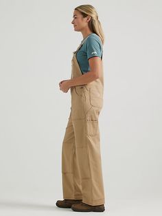 BUILT FOR ANYTHING For hard-working women on the move, the Women's Wrangler® RIGGS WORKWEAR® Relaxed Work Overall is the perfect companion. Combining fashion and function with rough and tumble craftsmanship, this relaxed-fit, loose leg cotton overall handles your toughest days with ease, with just enough stretch to always move with you. With adjustable straps and workwear favorite features, including a zippered chest pocket, zippered back thigh pocket, a utility thigh pocket, double-layered knee Warehouse Worker Outfit, Warehouse Worker Outfit Women, Construction Outfit, Wrangler Women, Hard Working Women, Working Women, Tough Day, Wrangler Jeans, Hard Working