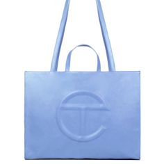 The Iconic Unisex Shopping Bag Is An Everyday Bag For Everyone. Featuring A Double Strap (Handles And Cross-Body Straps), Embossed Logo, A Main Compartment With Magnetic Snap Closure, Internal Laptop-Sized Compartment With Zipper Closure In Back And Additional Internal Pocket In Front. Made From Faux Leather And Twill Lining. Bag Is Packaged In A 100% Cotton Drawstring Bag With Screen-Printed Logo. Large Fits A Long Weekend And Is The Ultimate Carry-On. (Height 14 1/4", Width 19 1/4", Depth 8 Blue Rectangular Bag With Logo, Blue Rectangular Shoulder Bag With Logo, Everyday Blue Bags With Logo, Luxury Blue Shoulder Bag With Logo, Elegant Blue Bag With Logo, Elegant Blue Bags With Logo, Blue Top Handle Shoulder Bag With Logo, Blue Top Handle Bag With Logo, Blue Double Handle Shoulder Bag With Logo