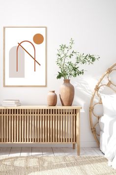 a white room with a wooden sideboard and vases on the table next to it