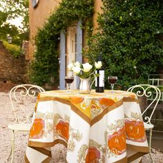 the table is set with two wine glasses on it