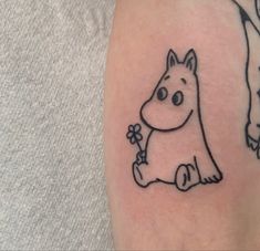 a small tattoo of a dog holding a flower