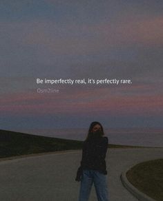 a woman standing in the middle of a road with a quote above her that reads be imperfectedly real, it's perfectly rare