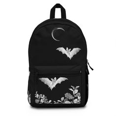 "Goth Bat Backpack | Gothic Backpack | Vampire Bat Backpack | Dark Academia Backpack | Goth Accessories | Goth Back To School Goth Bat Backpack, designed to inspire the bat lover in all of us, featuring jaunty bats flying in a midnight garden kept company by a crescent moon, on a black background. Perfect for lovers of bats, or gothic aesthetic. Crafted with 100% polyester, it guarantees both comfort and durability. Details: Adjustable shoulder straps ensure a custom fit, providing comfort as yo Black Gothic Bag For School, Gothic Black School Bag, Black Emo Style School Bag, Black Backpack For Halloween Cosplay, Black Gothic School Bag, Gothic Standard Backpack For Travel, Gothic Halloween Backpack, Gothic Style Standard Backpack For Travel, Gothic Black Backpack Bag