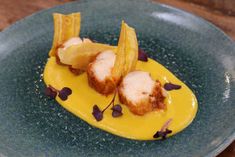 a blue plate topped with food on top of a wooden table