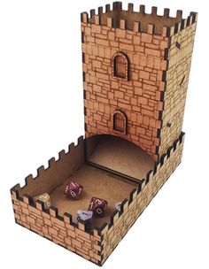 a cardboard castle with dice in the middle and two doors on each side that are open