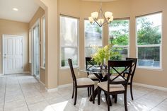 a dining room table with four chairs around it