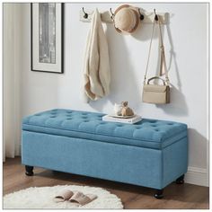 a blue bench sitting next to a white rug on top of a hard wood floor