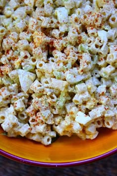 a bowl filled with macaroni salad on top of a table