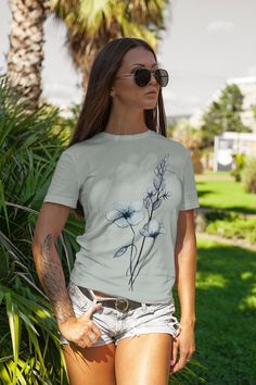 Jump into spring with this comfort colors wildflower oversized tee from an original watercolor by Amy Oberhansley.  Support a real artist while also wearing something unique and high quality.  You come to Etsy to get away from cheap mass fashion. Our shop never uses AI. Every piece is designed, painted and thought out carefully when designing our products. It's the Piece Makers Art difference!  Comfort Colors introduces its garment-dyed t-shirt; a fully customizable tee made 100% with ring-spun cotton. The soft-washed, garment-dyed fabric brings extra coziness to your wardrobe while the relaxed fit makes it an excellent daily choice. The double-needle stitching throughout the tee makes it highly durable while the lack of side-seams helps the shirt retain its tubular shape. .: 100% ring-spu Comfort Colors Shirt, Oversized Tee, Graphic Tees Women, Dye T Shirt, Comfort Colors, San Jose, Size Guide, Graphic Tee, Spun Cotton