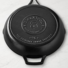 an empty cast iron skillet on a marble surface