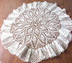 a crocheted doily on a wooden table