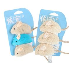 three small stuffed mice are tied to twine