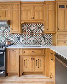 a kitchen with wooden cabinets and tile backsplash