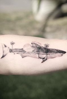 a black and white photo of a shark with palm trees on it's arm