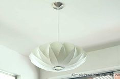 a white lamp hanging from the ceiling in a room