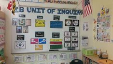 a bulletin board with pictures and magnets on it in a school classroom area that is decorated with american flags