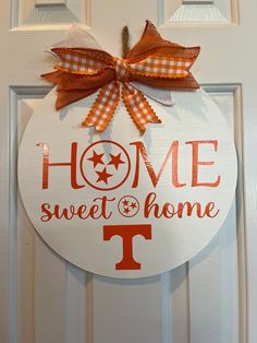 a door hanger with the words home sweet home and a bow on it's front