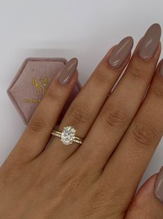 a woman's hand with a ring on it and a diamond in the middle