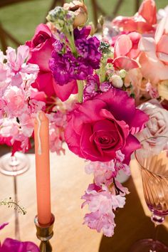 a table topped with pink and purple flowers