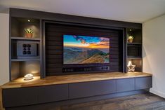 an entertainment center with built - in shelves and a flat screen tv on the wall