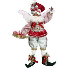 a figurine is dressed in red and white