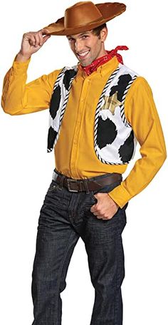 a man in a yellow shirt and cowboy hat is posing for the camera with his hand on his hip