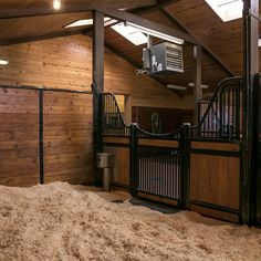 the inside of a barn with wood paneling and metal railings on each side