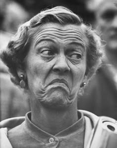 black and white photograph of an old woman making a face