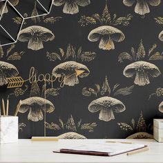 the wallpaper is black and gold with mushrooms on it