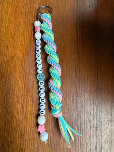 two different colored bracelets on top of a wooden table